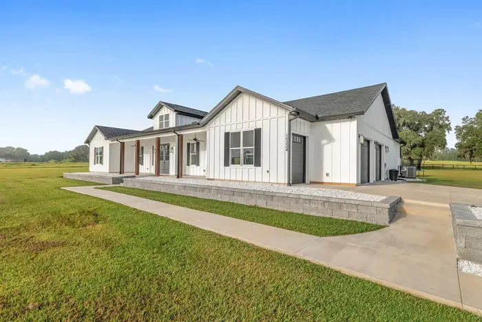 White-farmhouse-exterior-with-lawn